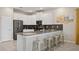 Modern kitchen featuring white cabinets, stainless steel appliances, and breakfast bar at 8834 Cabot Cliffs Dr, Davenport, FL 33896