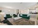 Open living space with green sofas, dining area, and kitchen view at 8834 Cabot Cliffs Dr, Davenport, FL 33896