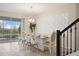 Spacious dining room with large table and modern chandelier, overlooking pool at 8834 Cabot Cliffs Dr, Davenport, FL 33896