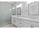Modern bathroom with double vanity, quartz countertop, and glass shower at 9832 Bucklow Hill Dr, Orlando, FL 32832