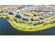 Aerial view of a lakefront community with numerous townhouses at 9832 Bucklow Hill Dr, Orlando, FL 32832