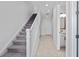 Bright entryway with staircase, tile flooring, and powder room at 9832 Bucklow Hill Dr, Orlando, FL 32832
