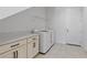 Bright laundry room with washer, dryer, and built-in cabinets at 9832 Bucklow Hill Dr, Orlando, FL 32832