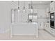 Modern white kitchen with island, stainless steel appliances, and glass pendant lights at 9832 Bucklow Hill Dr, Orlando, FL 32832