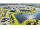An aerial view showcasing a community with a lake and numerous townhouses at 9832 Bucklow Hill Dr, Orlando, FL 32832