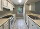 Efficient kitchen with white cabinets, a black stove, and double sink at 196 Riverbend Dr # 204, Altamonte Springs, FL 32714