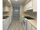 Kitchen with white cabinets, black stovetop and double sink at 196 Riverbend Dr # 204, Altamonte Springs, FL 32714