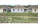 Rear view of a house showcasing three windows and a sliding glass door at 530 Ellie Ct, Apopka, FL 32703