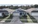 Three-house aerial view showing a neighborhood setting and surrounding landscape at 530 Ellie Ct, Apopka, FL 32703