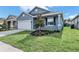 Newly constructed home with gray exterior, white garage door, and landscaping at 530 Ellie Ct, Apopka, FL 32703