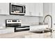 Modern kitchen sink and faucet with granite countertop at 530 Ellie Ct, Apopka, FL 32703