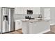 Modern kitchen with stainless steel refrigerator and granite countertops at 530 Ellie Ct, Apopka, FL 32703