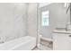 Bathroom with marble tile, bathtub, and vanity at 530 Ellie Ct, Apopka, FL 32703
