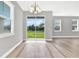 Dining room featuring a chandelier, sliding glass doors, and wood-look floors at 530 Ellie Ct, Apopka, FL 32703