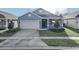 Newly built home with light blue exterior and two car garage at 530 Ellie Ct, Apopka, FL 32703