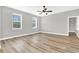 Bright bedroom with ceiling fan and light wood flooring at 530 Ellie Ct, Apopka, FL 32703