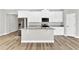 Kitchen with island, white cabinets and granite countertops at 530 Ellie Ct, Apopka, FL 32703