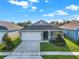 Gray house with white garage door and landscaping at 524 Ellie Ct, Apopka, FL 32703