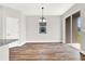 Dining room with chandelier, wood-look floors, and sliding glass doors at 524 Ellie Ct, Apopka, FL 32703