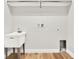 Laundry room with utility sink, built-in shelving and flooring at 524 Ellie Ct, Apopka, FL 32703