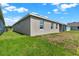 Rear view of a single story home with a small yard at 524 Ellie Ct, Apopka, FL 32703