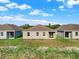 Three new homes with gray exteriors and brown roofs, viewed from behind at 524 Ellie Ct, Apopka, FL 32703