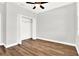 Bright bedroom with ceiling fan, wood-look flooring, and spacious closet at 524 Ellie Ct, Apopka, FL 32703