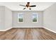 Spacious bedroom with wood-look flooring and ceiling fan at 524 Ellie Ct, Apopka, FL 32703