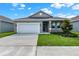 Front view of a single-story house with a yard at 524 Ellie Ct, Apopka, FL 32703