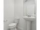 Clean and modern half bathroom with pedestal sink and white toilet at 28046 Poppy Ct, Leesburg, FL 34748