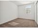 Bright bedroom with window, neutral walls and carpet at 28049 Poppy Ct, Leesburg, FL 34748