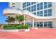 Elegant building entrance with red brick pavers and lush landscaping at 2545 S Atlantic Ave # 2107-2108, Daytona Beach Shores, FL 32118