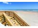 Private beach access with wooden stairs leading to the sand at 2545 S Atlantic Ave # 2107-2108, Daytona Beach Shores, FL 32118