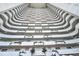 View of a building's interior, showing multiple floors with balconies and plants at 2545 S Atlantic Ave # 2107-2108, Daytona Beach Shores, FL 32118