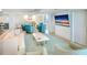 Comfortable Gathering room with teal armchairs and large TV at 2545 S Atlantic Ave # 2107-2108, Daytona Beach Shores, FL 32118