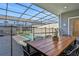 Relaxing patio with a wooden dining table and chairs, adjacent to the pool at 4270 Lana Ave, Davenport, FL 33897