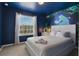 Bedroom with ocean-themed wall and a comfortable king-size bed at 4270 Lana Ave, Davenport, FL 33897