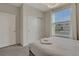 Bedroom with large window, white closet doors, and simple decor at 4270 Lana Ave, Davenport, FL 33897