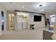 Upstairs game room with arcade game, TV, and adjacent laundry and bathroom at 4270 Lana Ave, Davenport, FL 33897