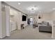 Game room with a comfortable sectional sofa, laundry area, and large screen TV at 4270 Lana Ave, Davenport, FL 33897