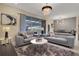 Bright living room with gray couches and a stylish chandelier at 4270 Lana Ave, Davenport, FL 33897