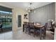 Dining room with table and chairs, and view of pool through sliding doors at 4270 Lana Ave, Davenport, FL 33897