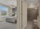 Bedroom with gray walls, a silver bed frame and a view of the bathroom at 4270 Lana Ave, Davenport, FL 33897