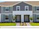 Two-story townhome with gray siding and light-colored doors at 4270 Lana Ave, Davenport, FL 33897