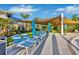 Relaxing pool deck with lounge chairs and shade umbrellas at 4270 Lana Ave, Davenport, FL 33897
