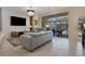Spacious living room with gray couches, a large TV, and access to a pool at 4270 Lana Ave, Davenport, FL 33897