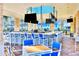 Outdoor community bar with blue and white seating and TVs at 4270 Lana Ave, Davenport, FL 33897