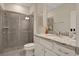 Modern bathroom with a walk-in shower, granite countertop, and white cabinets at 4270 Lana Ave, Davenport, FL 33897