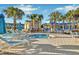 Community hot tub surrounded by lounge chairs and palm trees at 4270 Lana Ave, Davenport, FL 33897