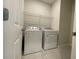 Bright laundry room with washer, dryer and shelving at 14154 Dove Hollow Dr, Orlando, FL 32824